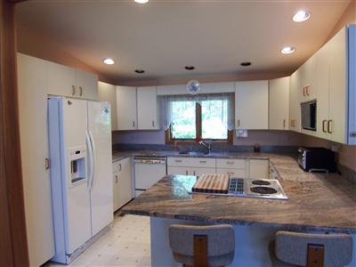 Undisclosed Address Centerville, MA 02632 - Photo 11 of 21 a kitchen with stainless steel appliances granite countertop a refrigerator a stove and a sink