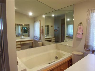Undisclosed Address Centerville, MA 02632 - Photo 15 of 21 a bathroom with a tub a sink and a large mirror