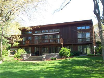 Undisclosed Address Centerville, MA 02632 - Photo 21 of 21 a front view of a house with a yard table and chairs