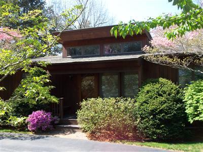 Undisclosed Address Centerville, MA 02632 - Photo 3 of 21 a front view of a house with a yard
