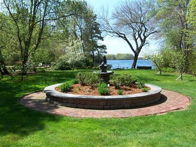 Undisclosed Address Centerville, MA 02632 - Photo 7 of 21 a garden with a fountain and large trees
