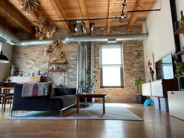 14 North Sangamon Street, Unit 403 Chicago, IL 60607 - Photo 2 of 16 a living room with furniture and a window