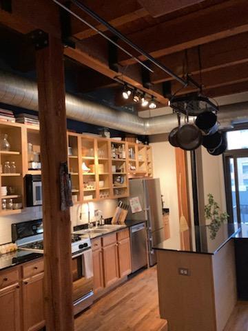 14 North Sangamon Street, Unit 403 Chicago, IL 60607 - Photo 4 of 16 a view of a kitchen with wooden floor