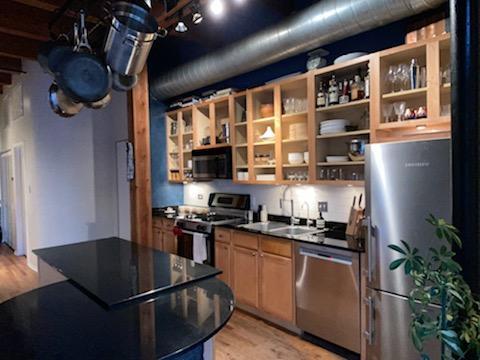14 North Sangamon Street, Unit 403 Chicago, IL 60607 - Photo 5 of 16 a kitchen with stainless steel appliances granite countertop a sink a stove and a refrigerator