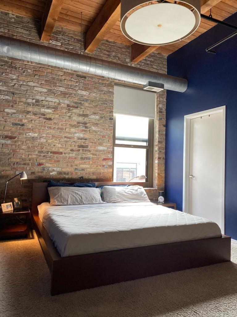 14 North Sangamon Street, Unit 403 Chicago, IL 60607 - Photo 6 of 16 a bedroom with a bed and dresser