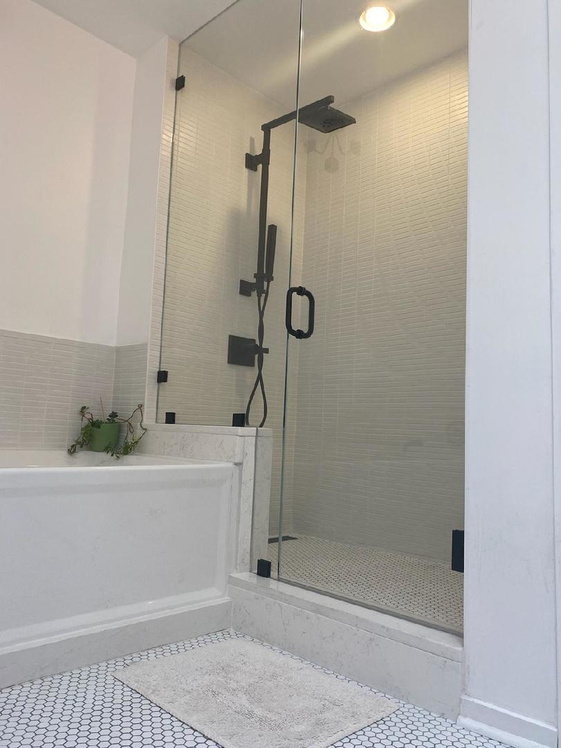 14 North Sangamon Street, Unit 403 Chicago, IL 60607 - Photo 8 of 16 a bathroom with a bathtub and shower