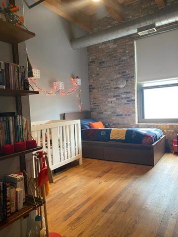 14 North Sangamon Street, Unit 403 Chicago, IL 60607 - Photo 10 of 16 a living room with lots of furniture and a book shelf