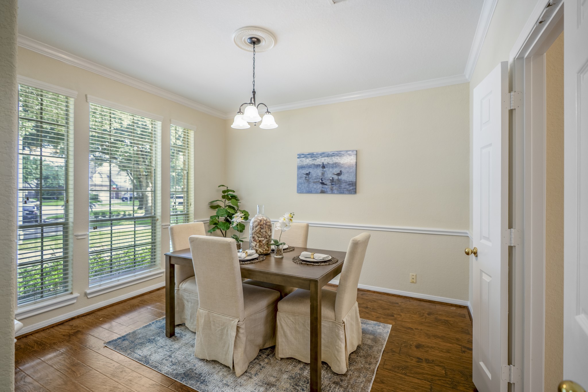 5807 Sequoia Trace Court Spring, TX 77379 - Photo 6 of 50 Across the foyer, the formal dining room adds another elegant entertaining space, with tall windows, laminate flooring, crown molding, and easy access toward the kitchen and pantry.