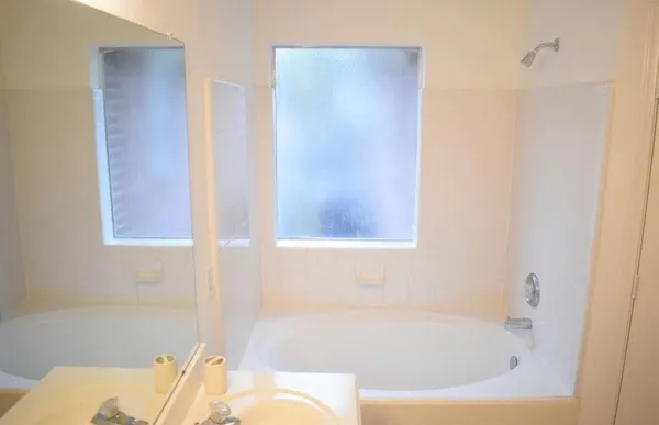 a bathroom with a shower and a sink