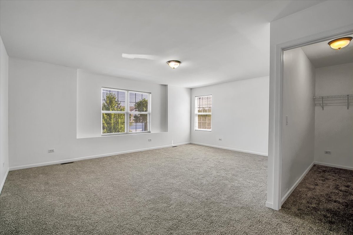 4932 Montauk Drive, Unit 4932 Plainfield, IL 60586 - Photo 12 of 23 an empty room with windows