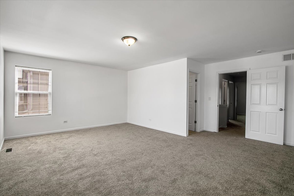 4932 Montauk Drive, Unit 4932 Plainfield, IL 60586 - Photo 14 of 23 a view of an empty room with a window