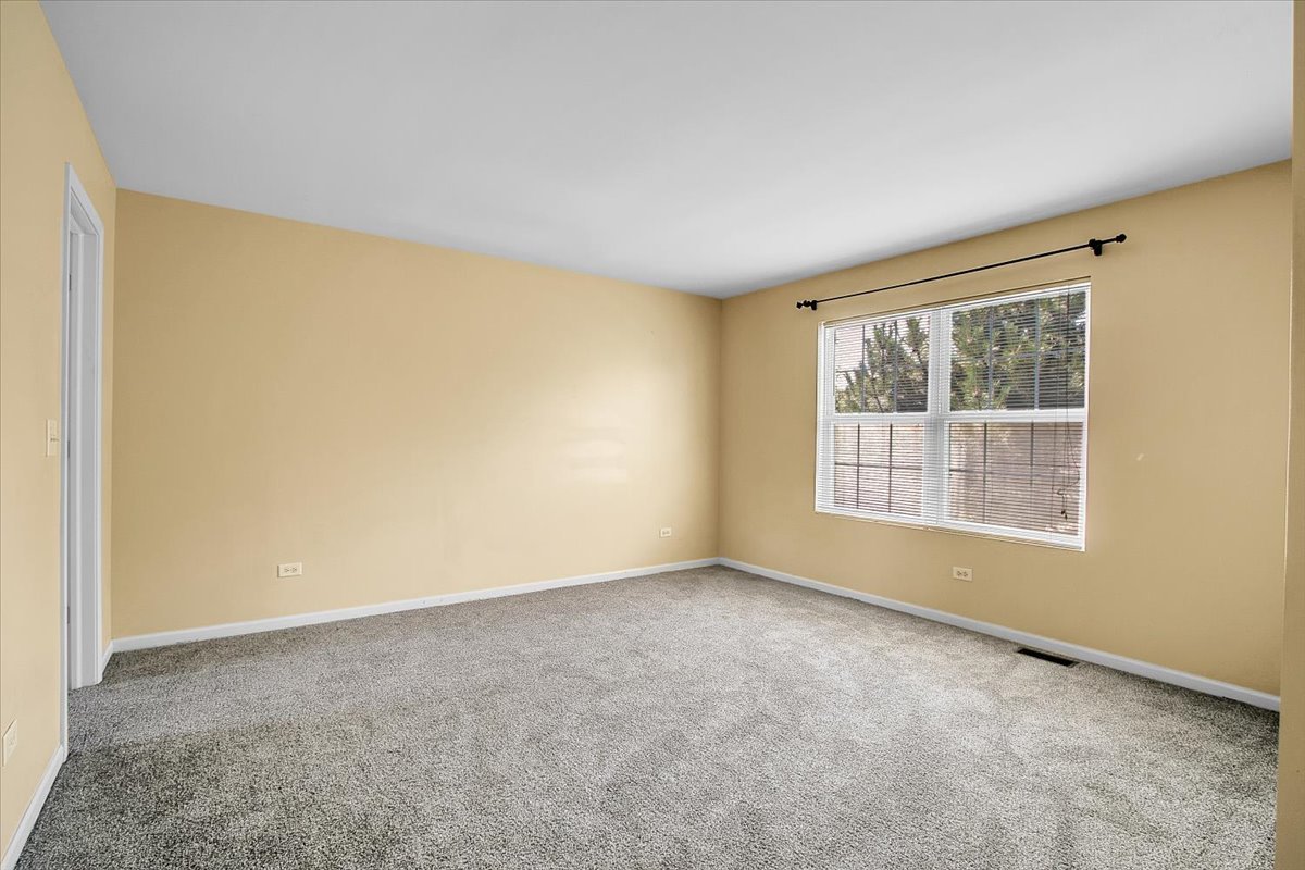 4932 Montauk Drive, Unit 4932 Plainfield, IL 60586 - Photo 20 of 23 a view of an empty room with a window
