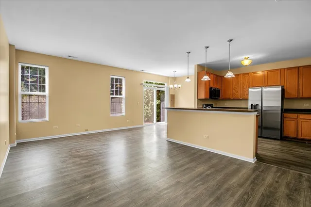 a view of kitchen with wooden floor and electronic appliances