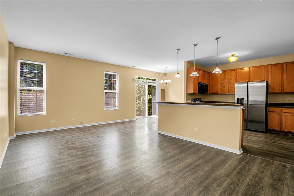 4932 Montauk Drive, Unit 4932 Plainfield, IL 60586 - Photo 4 of 23 a view of kitchen with wooden floor and electronic appliances