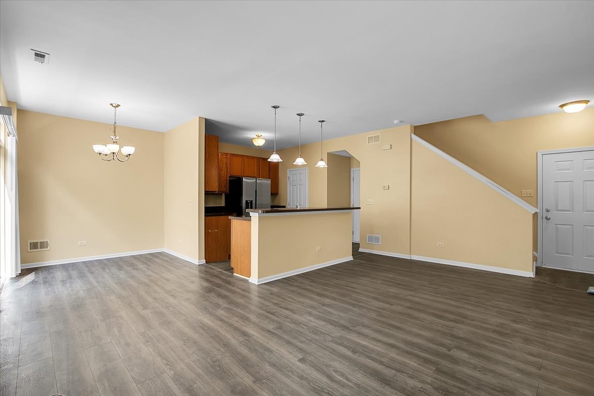 4932 Montauk Drive, Unit 4932 Plainfield, IL 60586 - Photo 5 of 23 a view of a kitchen with a refrigerator and a stove top oven