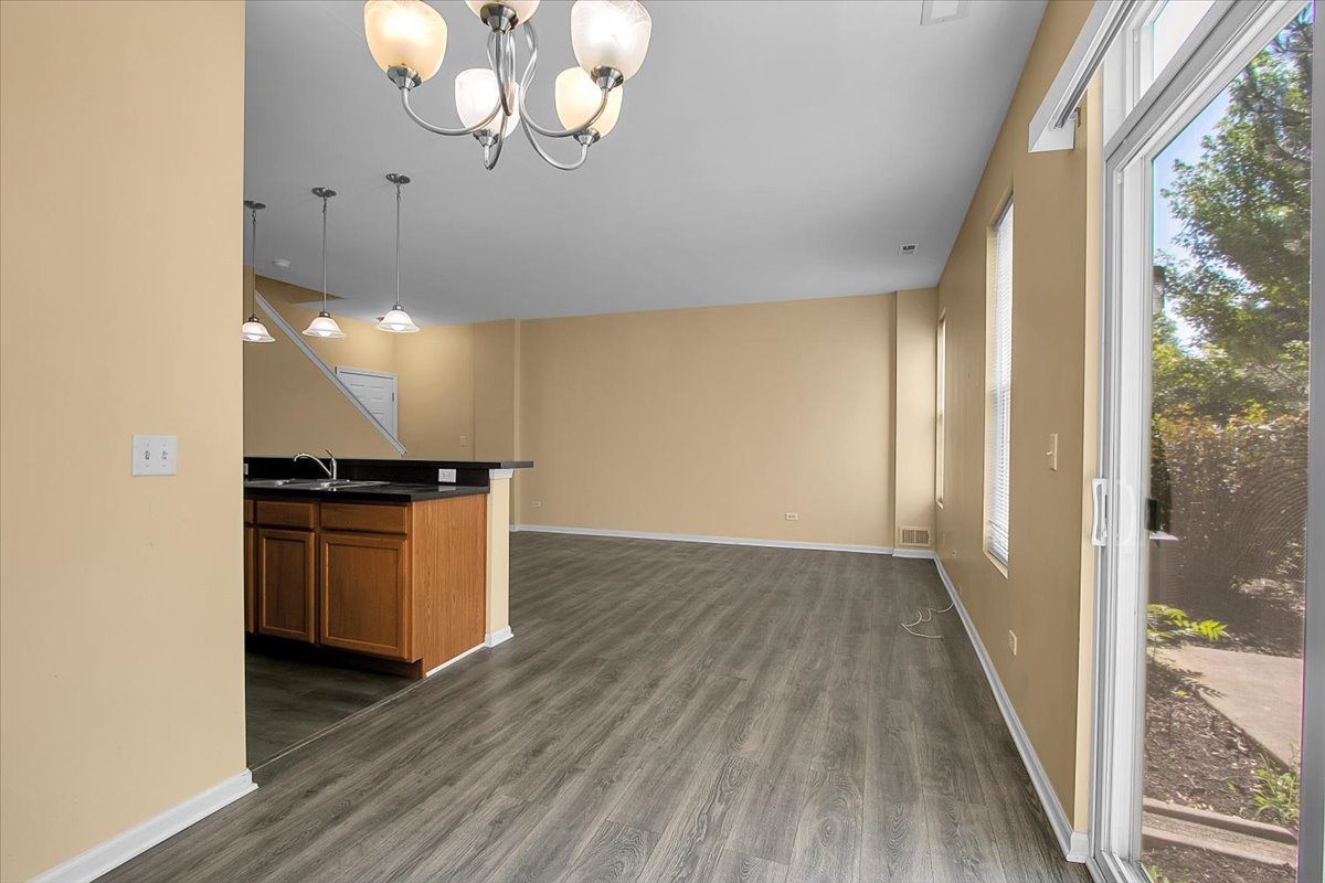4932 Montauk Drive, Unit 4932 Plainfield, IL 60586 - Photo 7 of 23 a view of kitchen and wooden floor