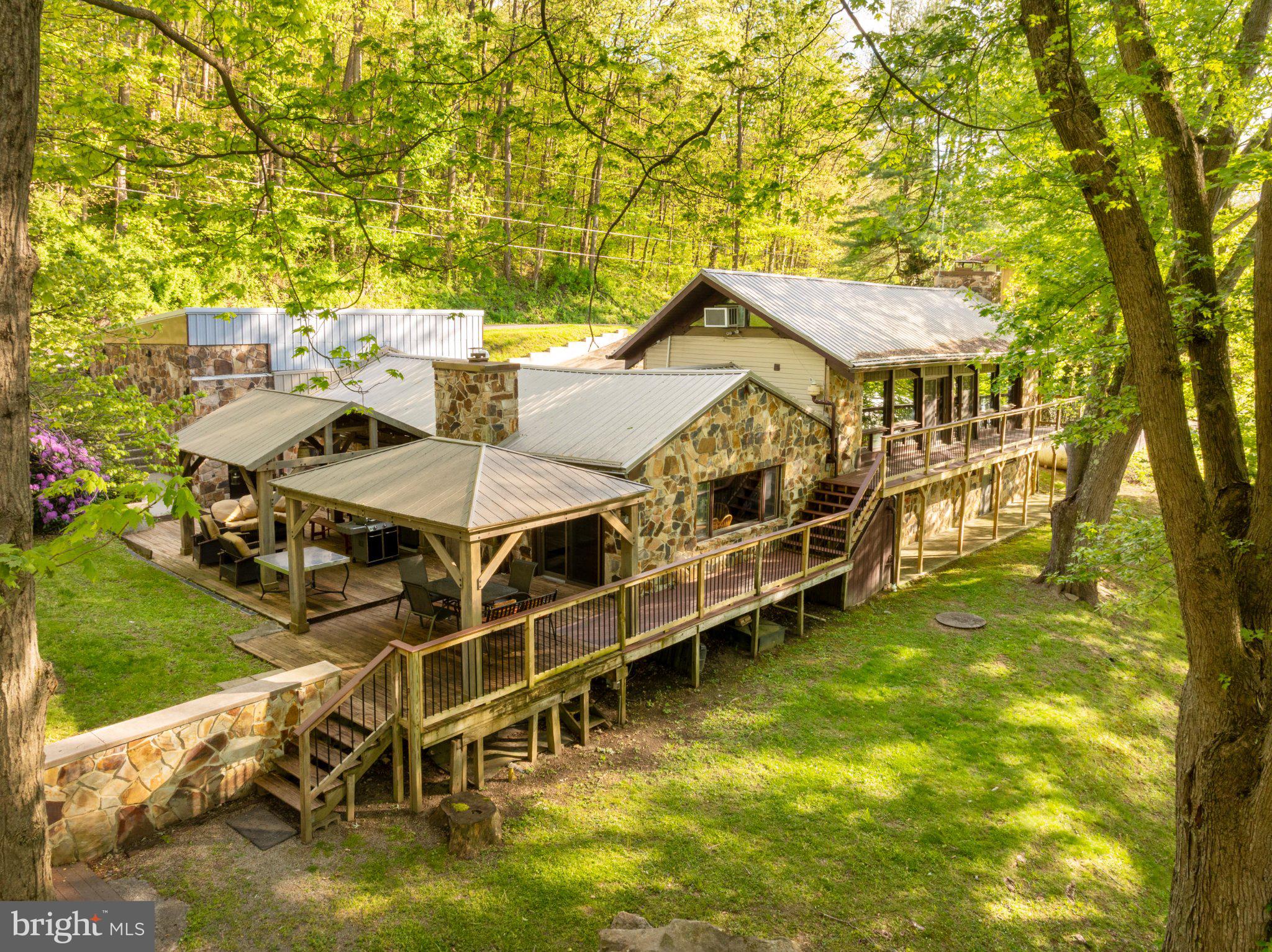 750 Lake Side Road Addison, PA 15411 - Photo 3 of 51 Serene stone retreat in lush greenery.