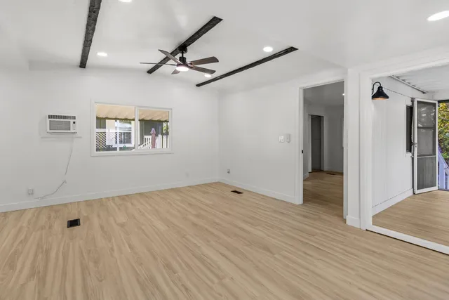 wooden floor in an empty room with a window