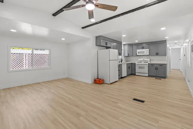 a view of a kitchen with a sink cabinets and wooden floor