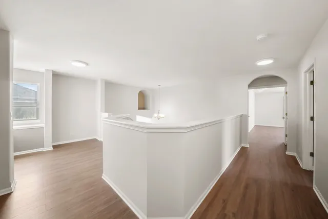 a view of hallway with wooden floor