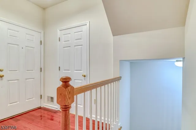 an empty room with fan and entrance