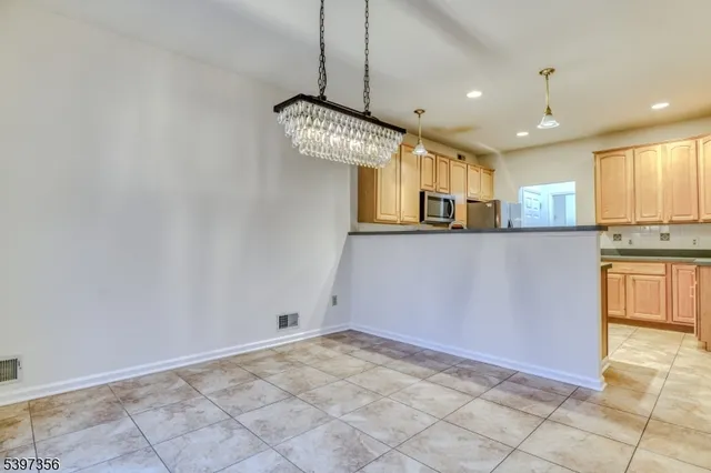 a kitchen with cabinets appliances and a sink