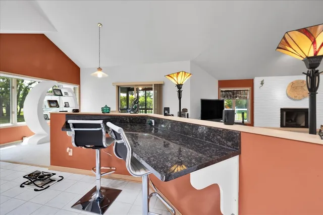 a kitchen with stainless steel appliances granite countertop a sink and a stove