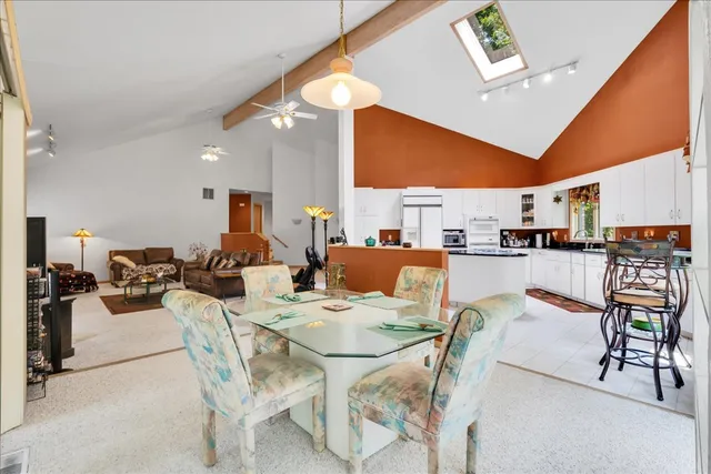 a living room with lots of furniture and kitchen view