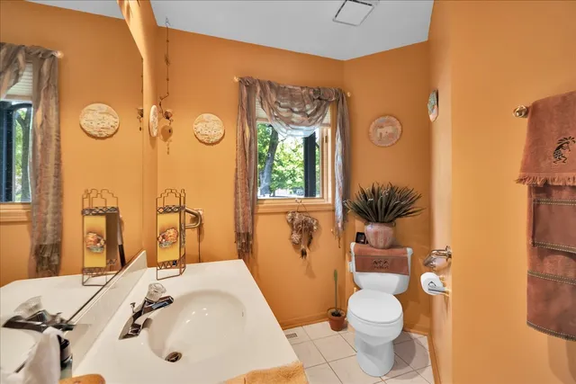 a bathroom with a sink a toilet and shower curtain