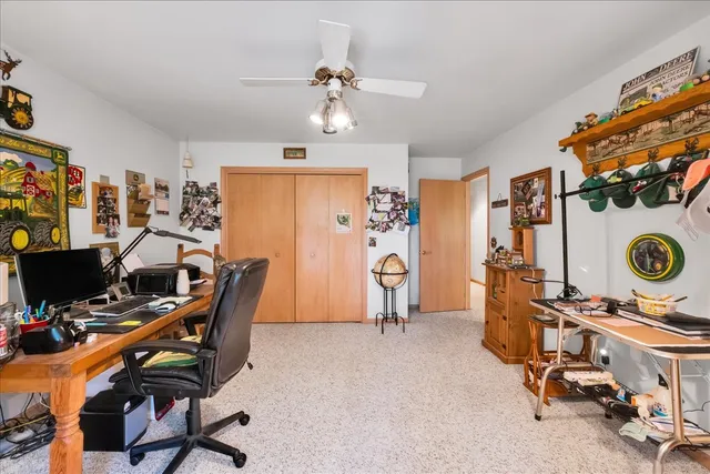 a view of a workspace with furniture and a window
