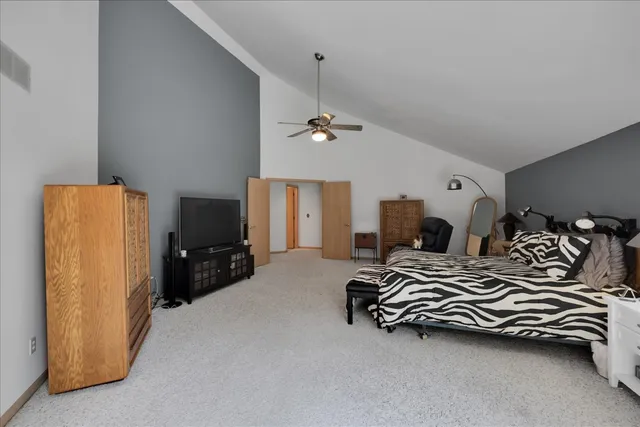 a spacious bedroom with a bed and cabinets