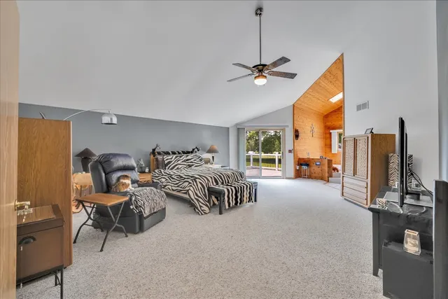 a bedroom with furniture and a flat screen tv