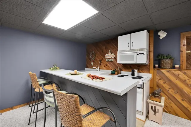 a utility room with a sink a counter space and a window