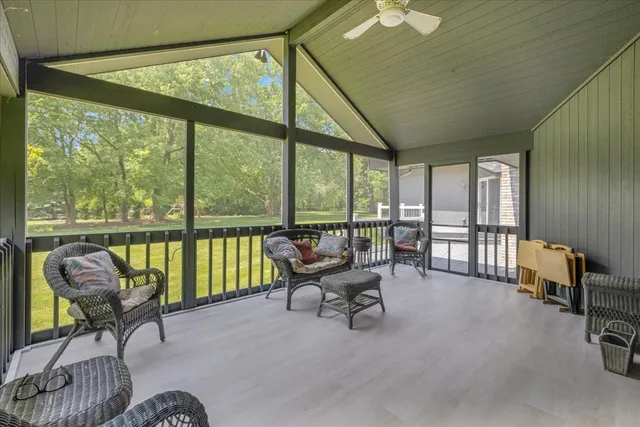 a living room with furniture and a floor to ceiling window