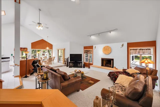 a living room with furniture a fireplace and a flat screen tv