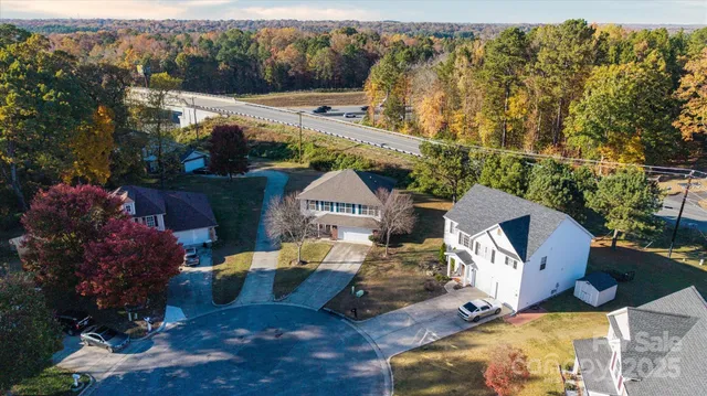 an aerial view of a house with a yard basket ball court and outdoor seating