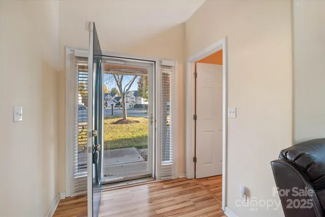 a view of an entryway with wooden floor