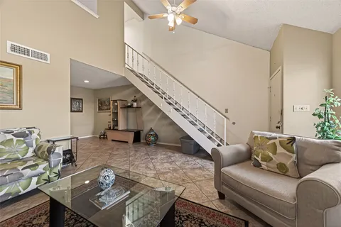 a living room with furniture and a stairs
