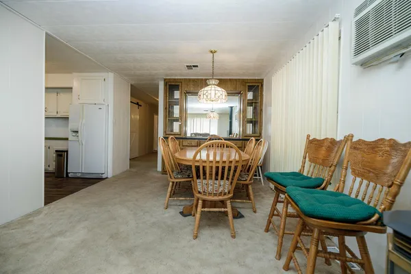 a view of a livingroom with furniture window and a kitchen