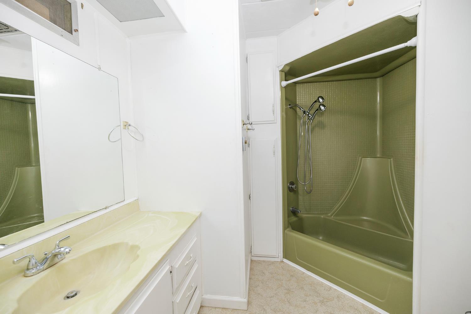 4837 Faith Home Road, Unit 4 Ceres, CA 95307 - Photo 23 of 42 a bathroom with a granite countertop sink a mirror and shower