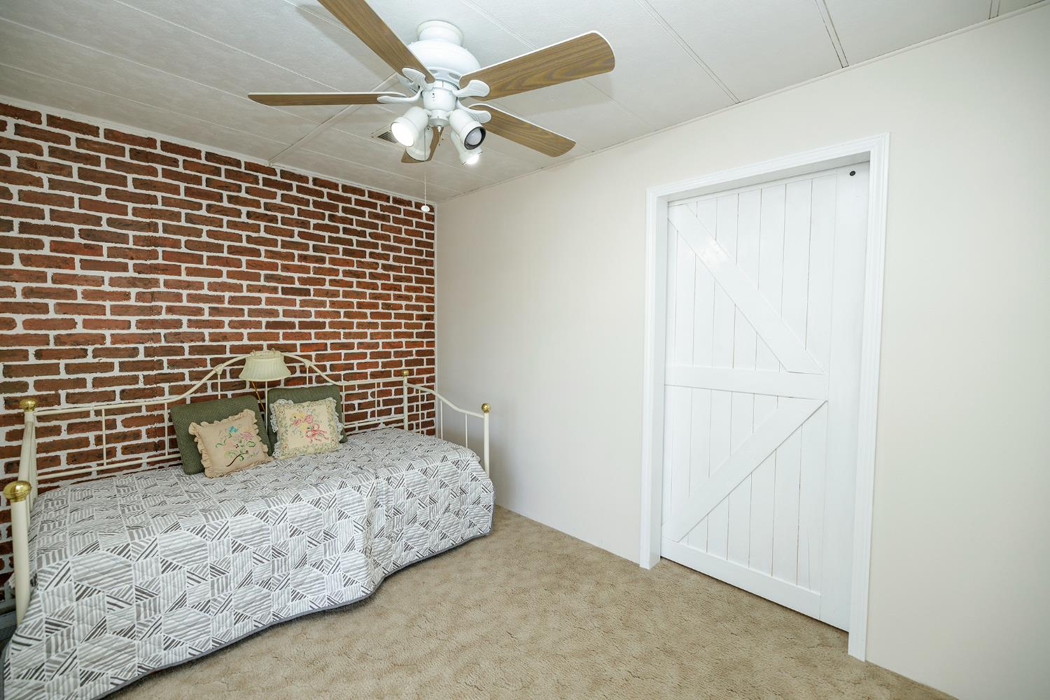 4837 Faith Home Road, Unit 4 Ceres, CA 95307 - Photo 31 of 42 a bedroom with a bed and a ceiling fan