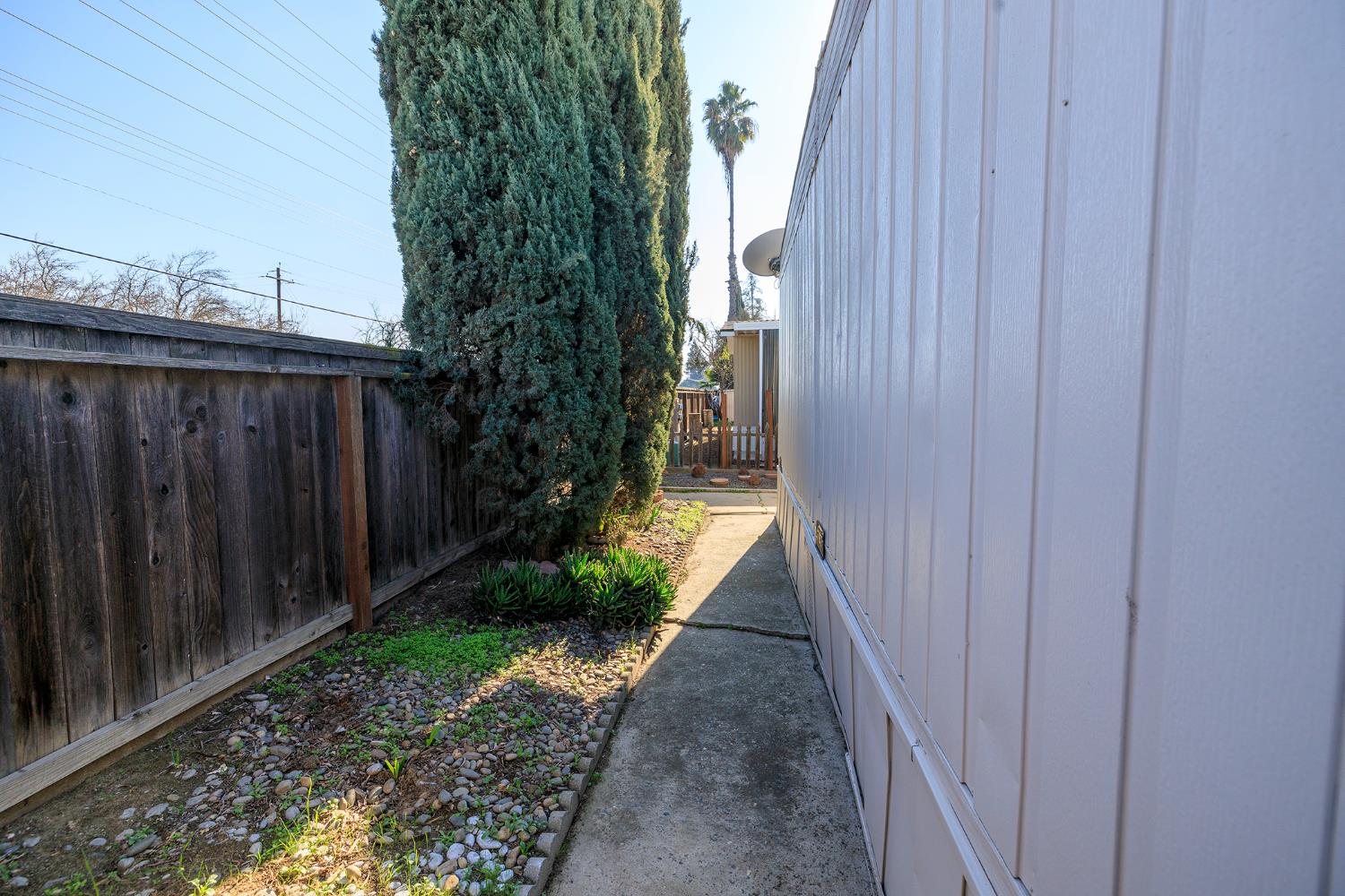 4837 Faith Home Road, Unit 4 Ceres, CA 95307 - Photo 36 of 42 a view of a pathway with a wooden fence