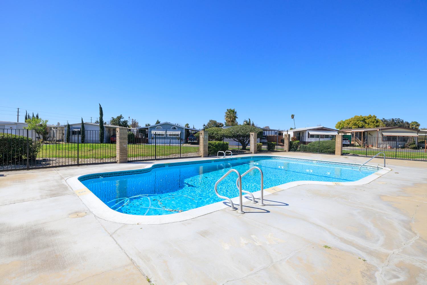 4837 Faith Home Road, Unit 4 Ceres, CA 95307 - Photo 42 of 42 a swimming pool with outdoor seating and yard