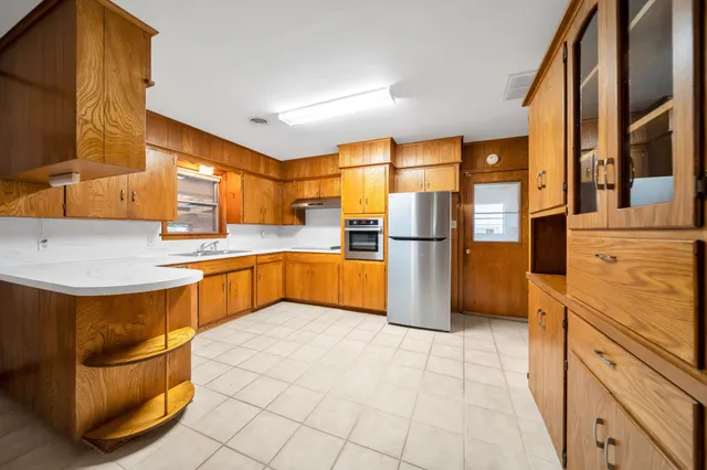 a kitchen with stainless steel appliances granite countertop a sink and cabinets