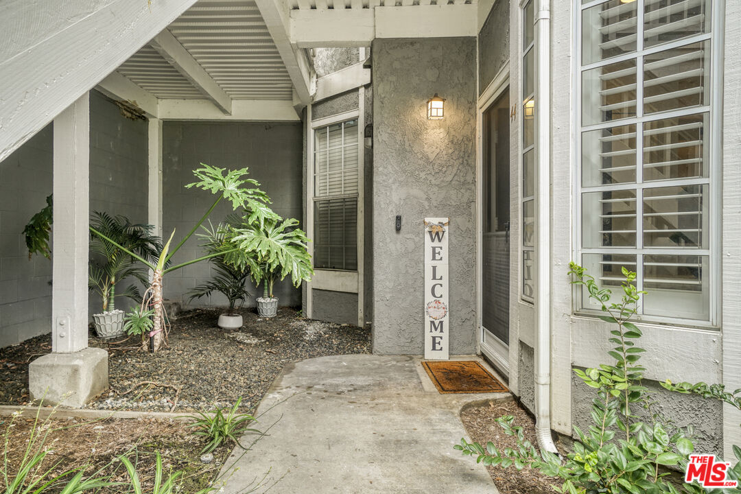 10401 Garden Grove Boulevard, Unit 44 Garden Grove, CA 92843 - Photo 1 of 26 a potted plant sitting in front of a door