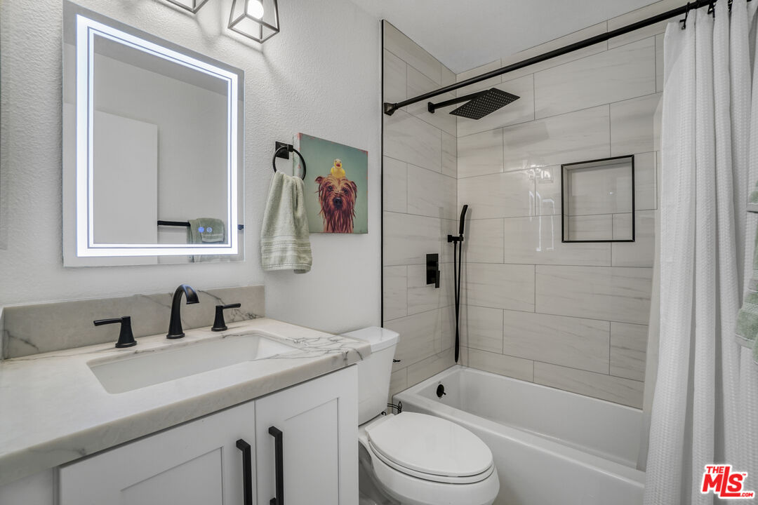10401 Garden Grove Boulevard, Unit 44 Garden Grove, CA 92843 - Photo 12 of 26 a bathroom with a sink toilet and shower