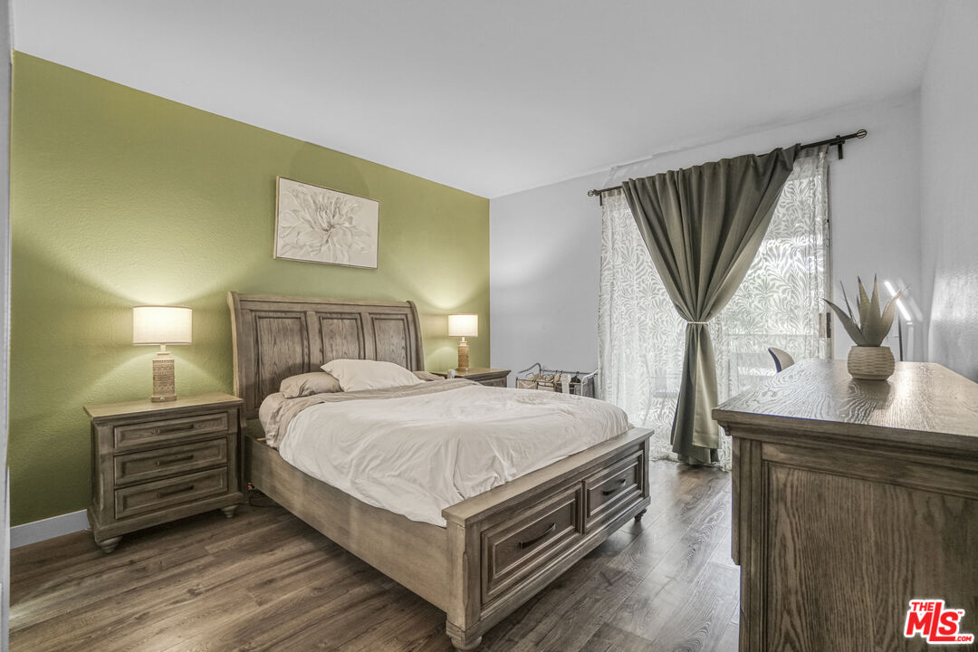 10401 Garden Grove Boulevard, Unit 44 Garden Grove, CA 92843 - Photo 15 of 26 a bedroom with a bed a mirror and desk