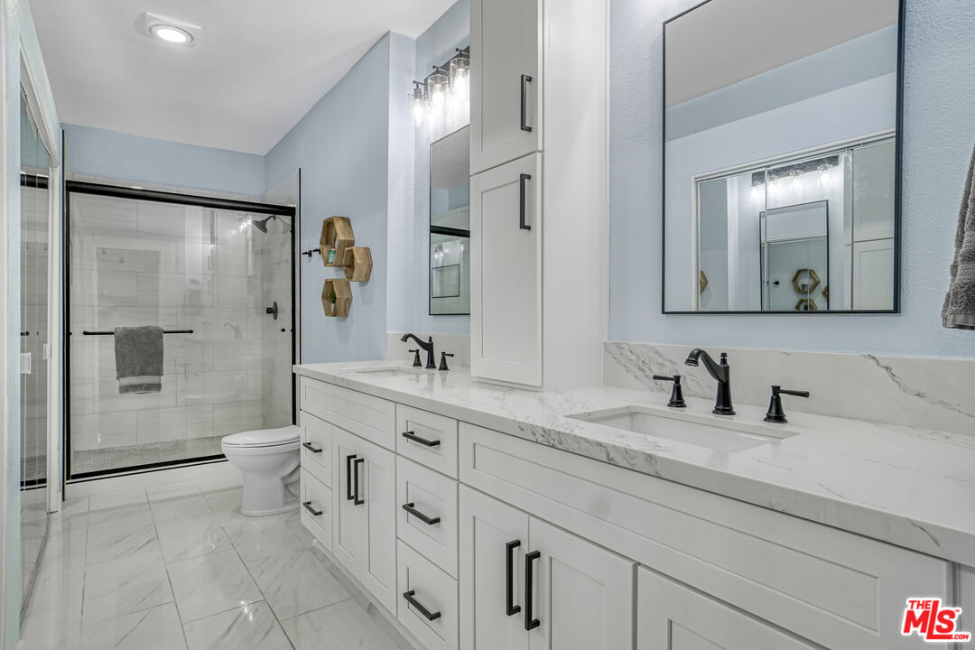 10401 Garden Grove Boulevard, Unit 44 Garden Grove, CA 92843 - Photo 17 of 26 a bathroom with a granite countertop sink mirror and double