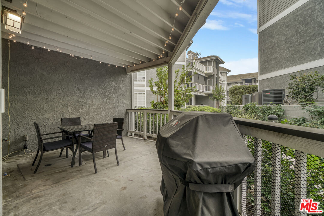 10401 Garden Grove Boulevard, Unit 44 Garden Grove, CA 92843 - Photo 19 of 26 a balcony with table and chairs