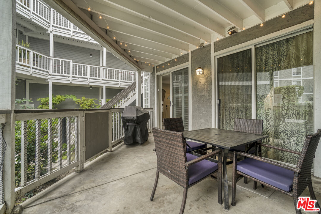 10401 Garden Grove Boulevard, Unit 44 Garden Grove, CA 92843 - Photo 20 of 26 a balcony with furniture and wooden floor